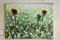 a painting of dandelion flowers hanging on a wall