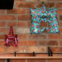two balloons hanging from a brick wall