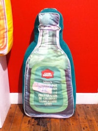 a pillow with a bottle on it