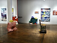 an art gallery with a lot of paintings on the walls