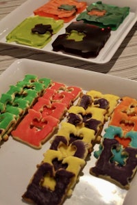 a tray of colorful shaped cookies on a table