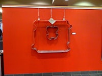 a cookie cutter hanging on a red wall