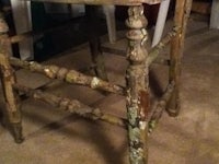 an old wooden stool in a room