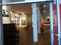 a doorway to an art gallery with a piano